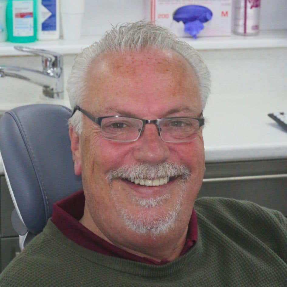 patient before and after implant treatment in dentist leicester